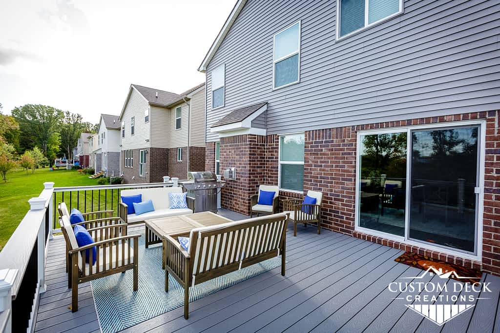 Seating area with grill, chairs, and a coffee table on a deck outside in Canton Michigan