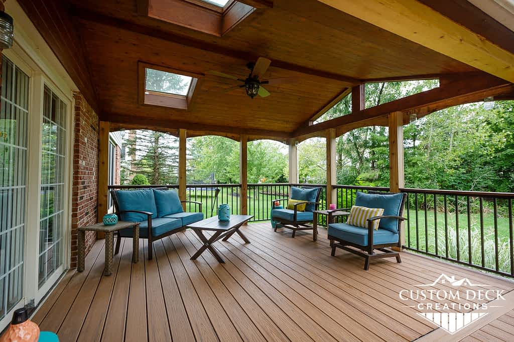 Outdoor brown deck with a wooden covered roof and outdoor seating