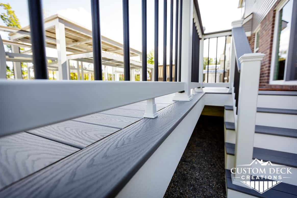 Close up of a grey deck with white fascia and stairs built by Custom Deck Creations