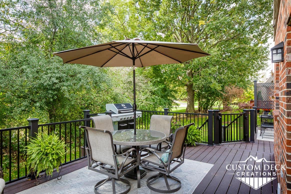 Patio table with umbrella in a backyard deck in Ann Arbor Michigan