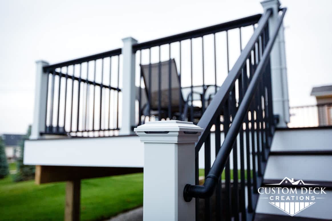 Closeup view of lighting in a railing post of an outdoor Trex composite deck
