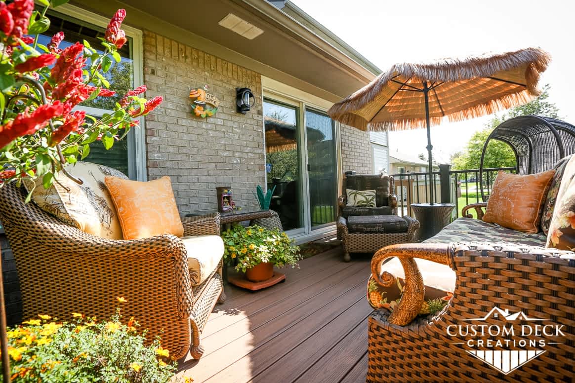 Brown backyard deck off a condo decorated with Hawaii theme