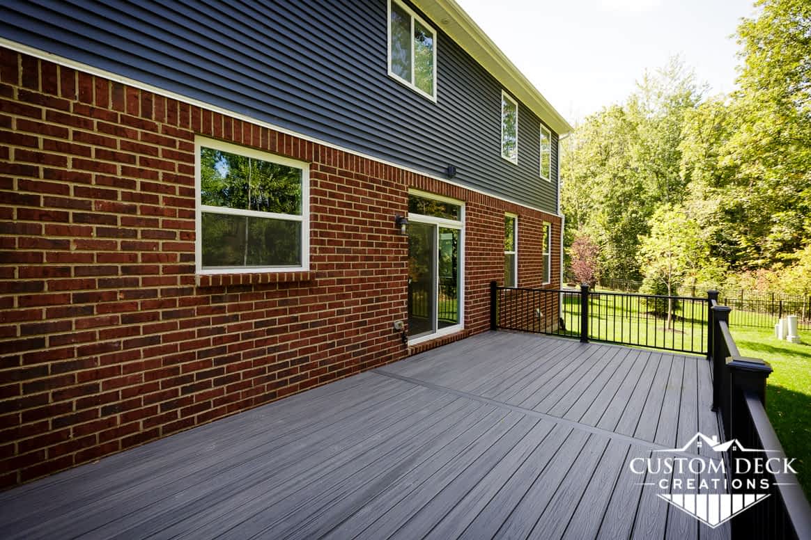 Grey composite backyard deck with black railing on a new construction home in Canton Michigan