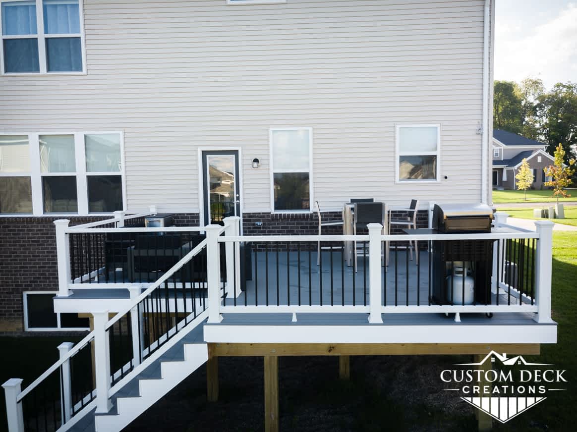 Grey and white composite Trex backyard deck built by Custom Deck Creations