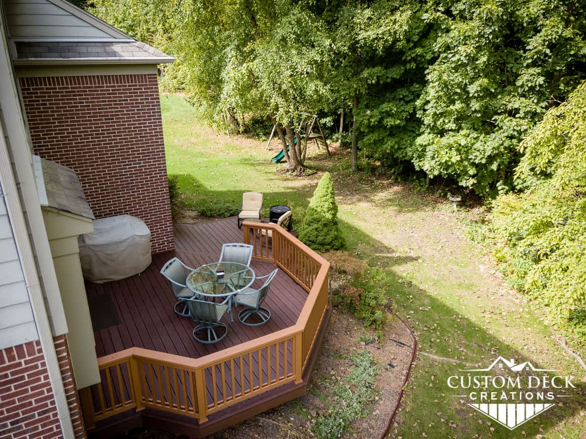 Aerial view of a brown deck in an open backyard