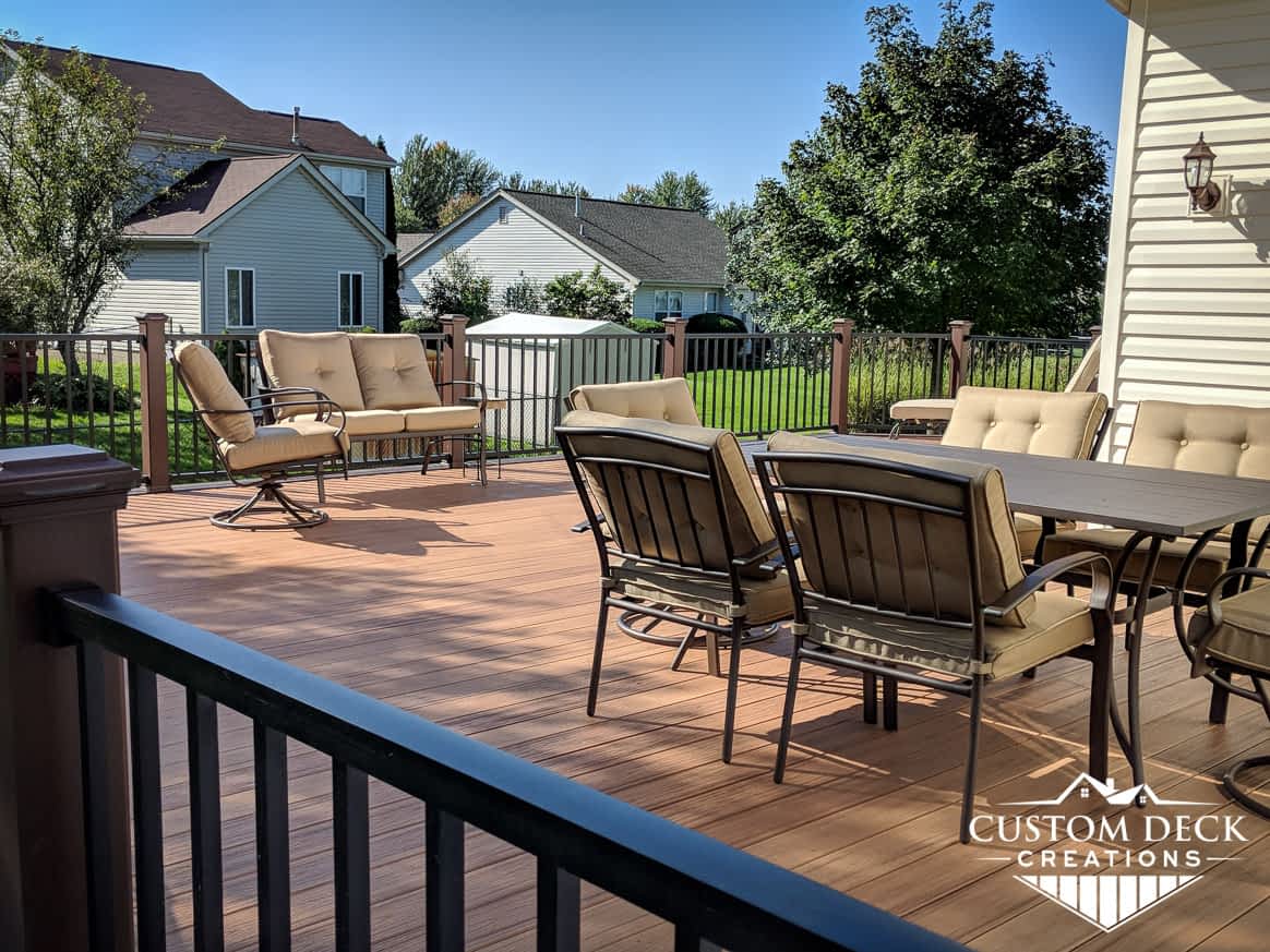 Large backyard composite deck in brown and black