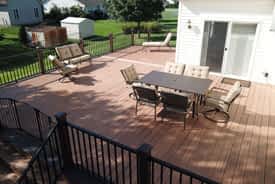 Large outdoor composite deck with aluminum railing and lounge furniture