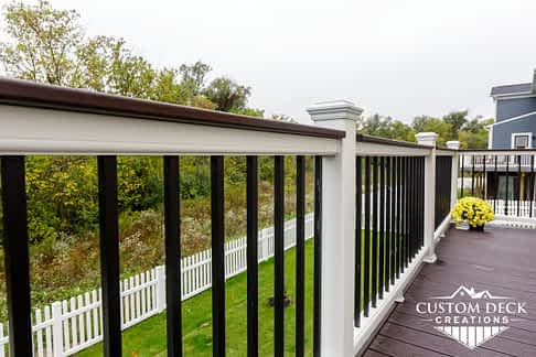 White and black railing on a composite deck